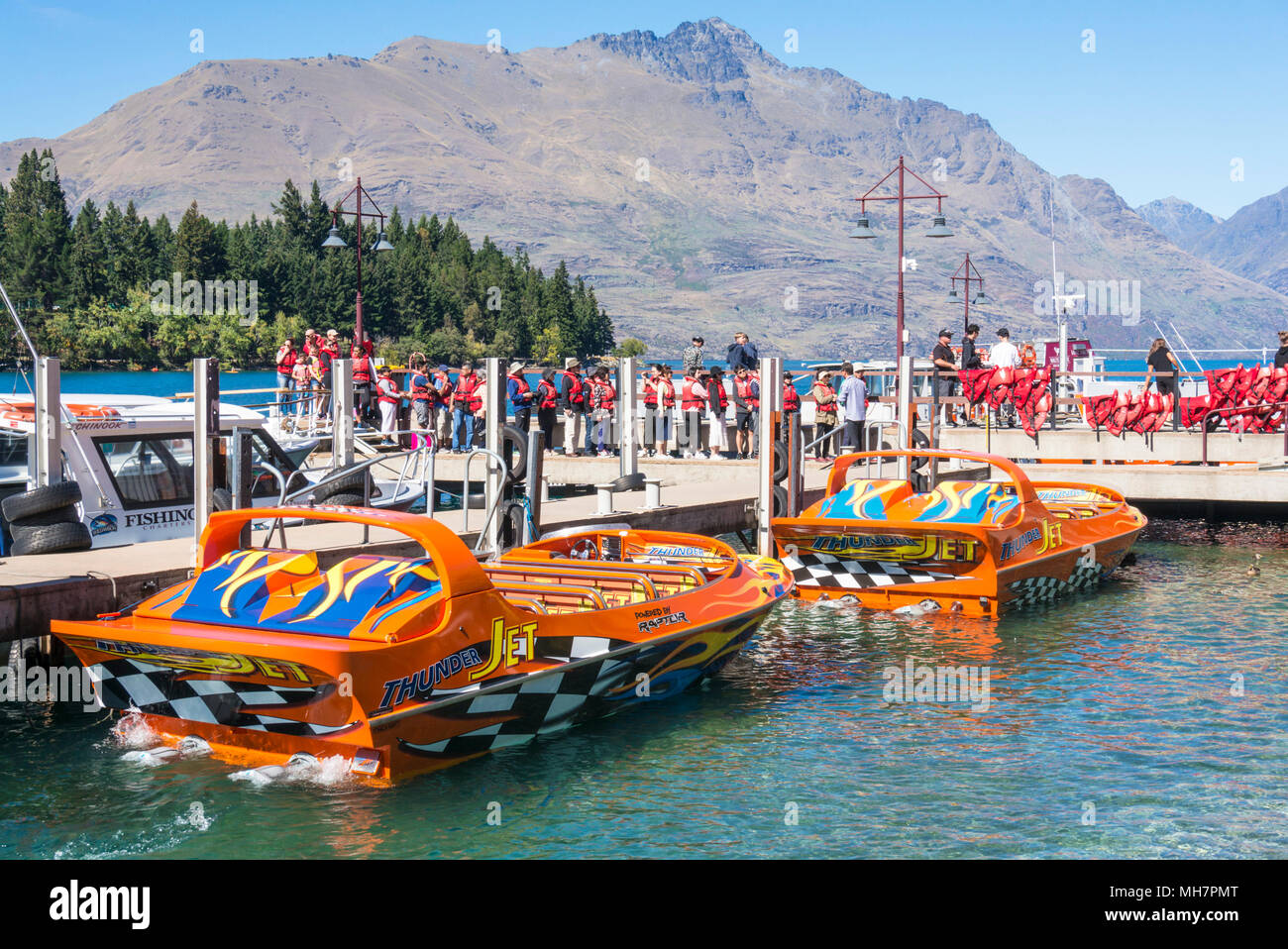 Queenstown South Island new zealand  toursists queueing for a thrilling jet boat ride on Lake wakatipu Queenstown south island new zealand nz Stock Photo