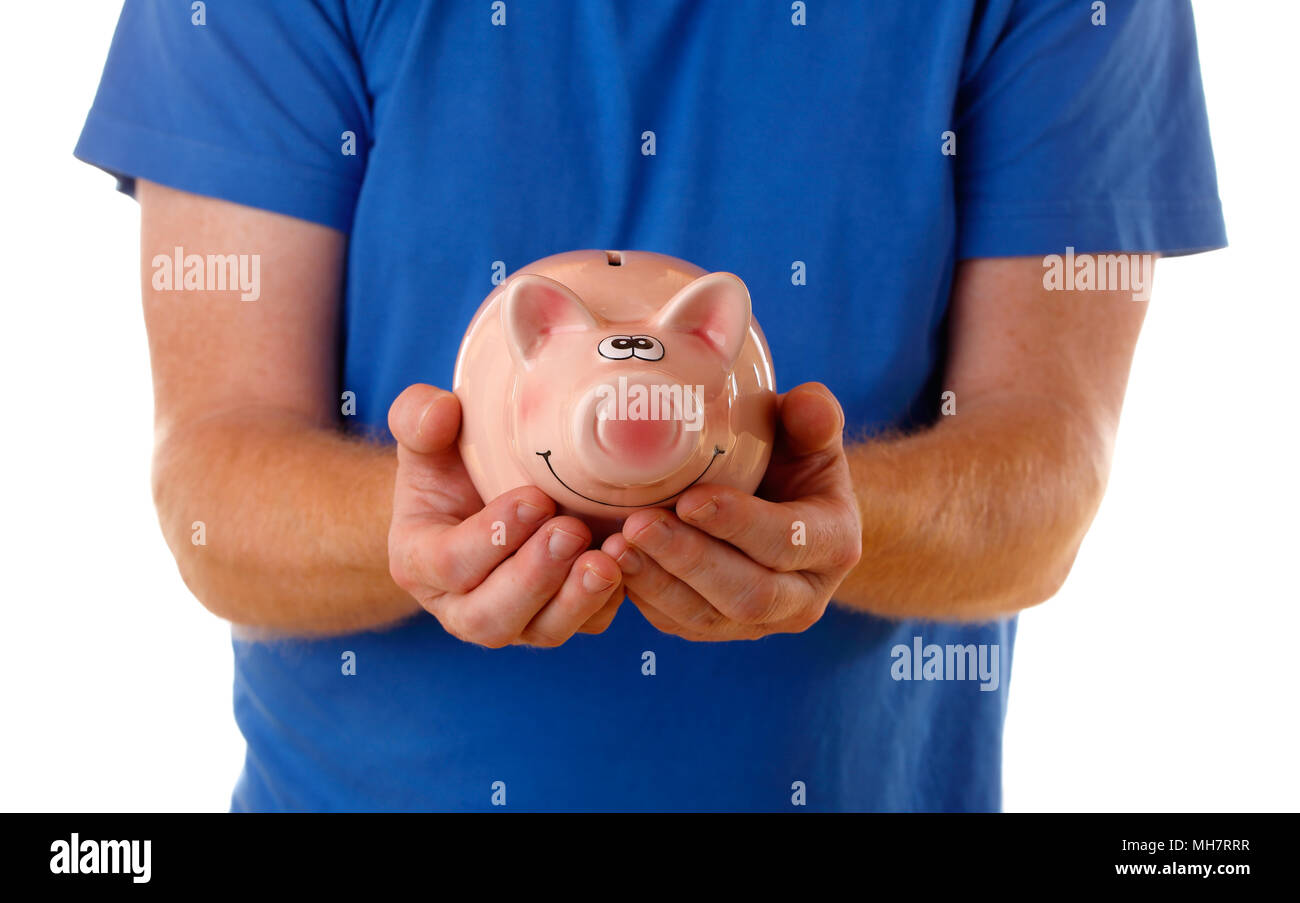 Close up of a person wearing blue short-sleeved shirt holding a piggi bank. Stock Photo