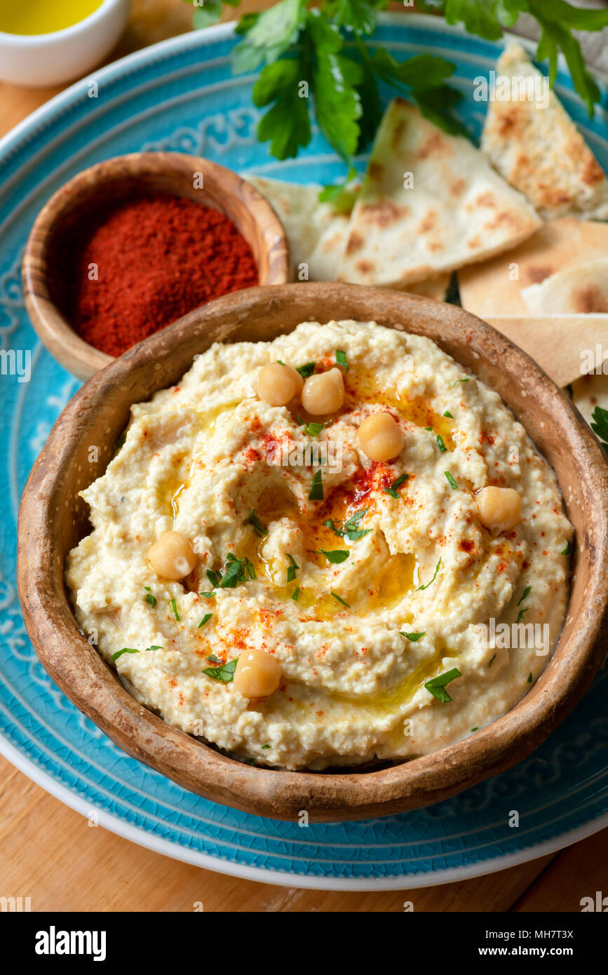 Chickpea hummus with paprika and pita chips. Homemade hummus. Healthy vegan chickpea spread in bowl. Closeup view, selective focus Stock Photo