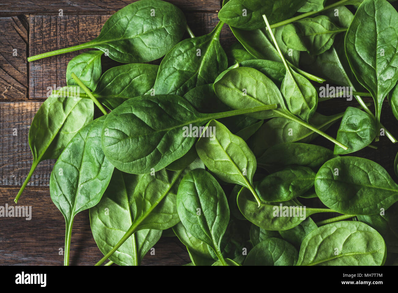 Baby spinach leaf on wood as a background. Horizontal composition. Detox, healthy lifestyle, healthy eating, vegan diet concept Stock Photo