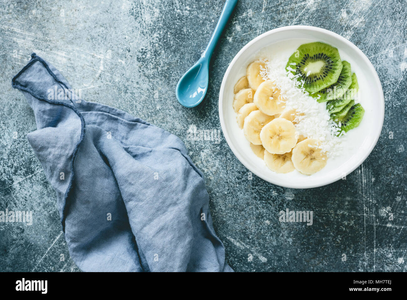 Yogurt with banana, kiwi and coconut bowl. Vegan yogurt with fruits. Healthy eating, dieting