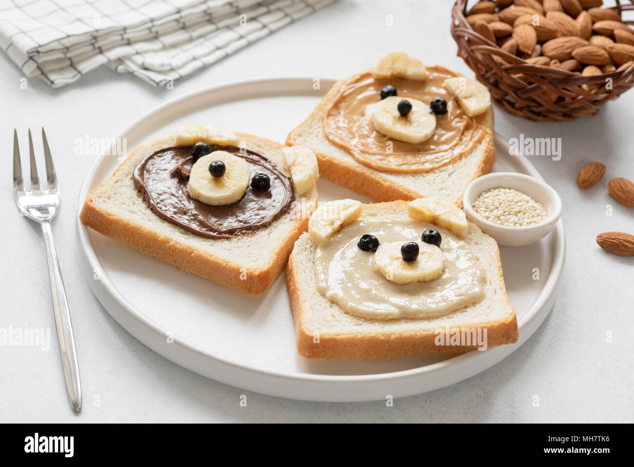 Kids breakfast meal Bread with nut butter and banana. Animal face toast ...