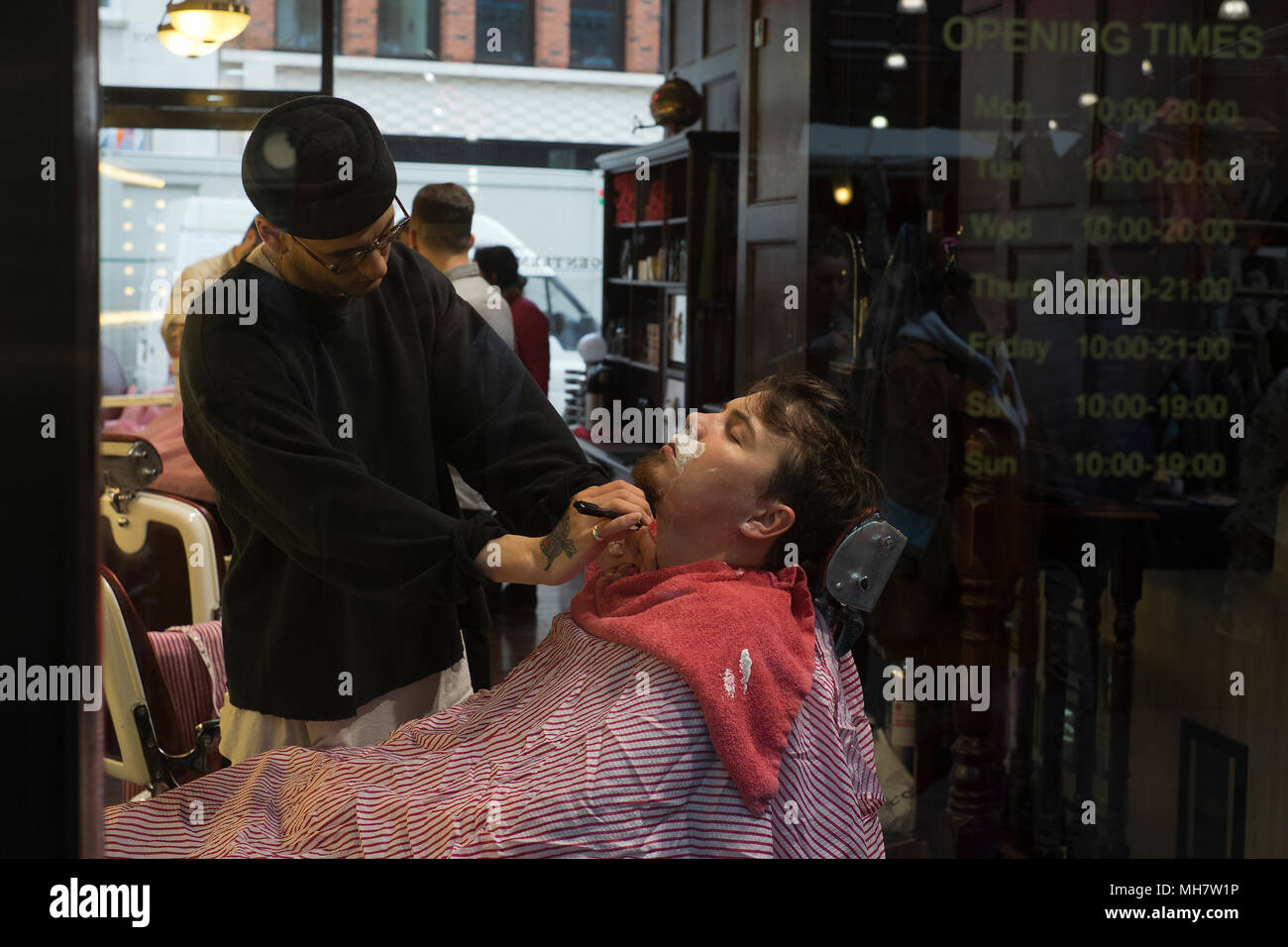 Man having a shave in Barber shop at the Old Spitalfields Market East