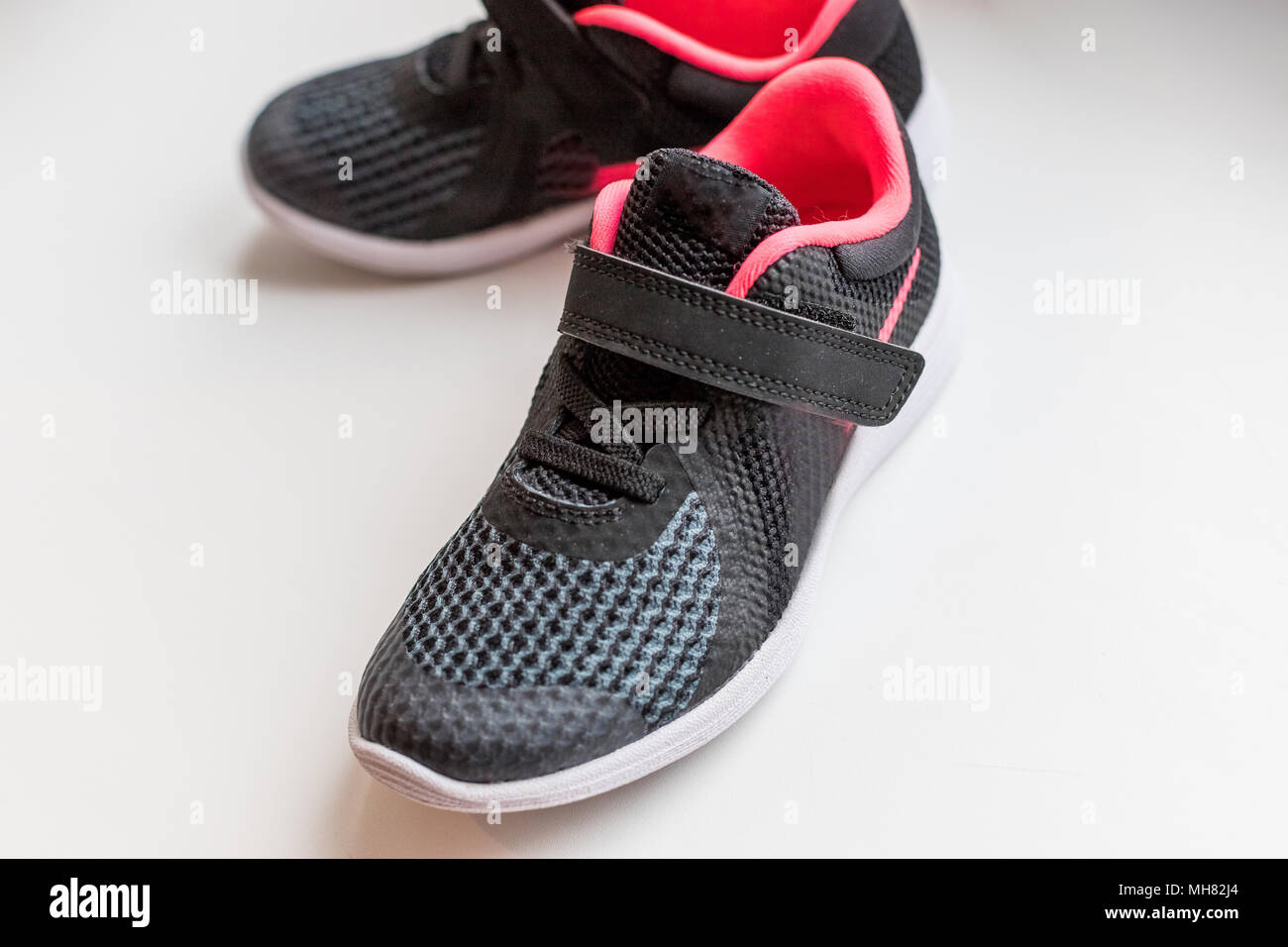 New pink, black sport shoes isolated on white background.kids running