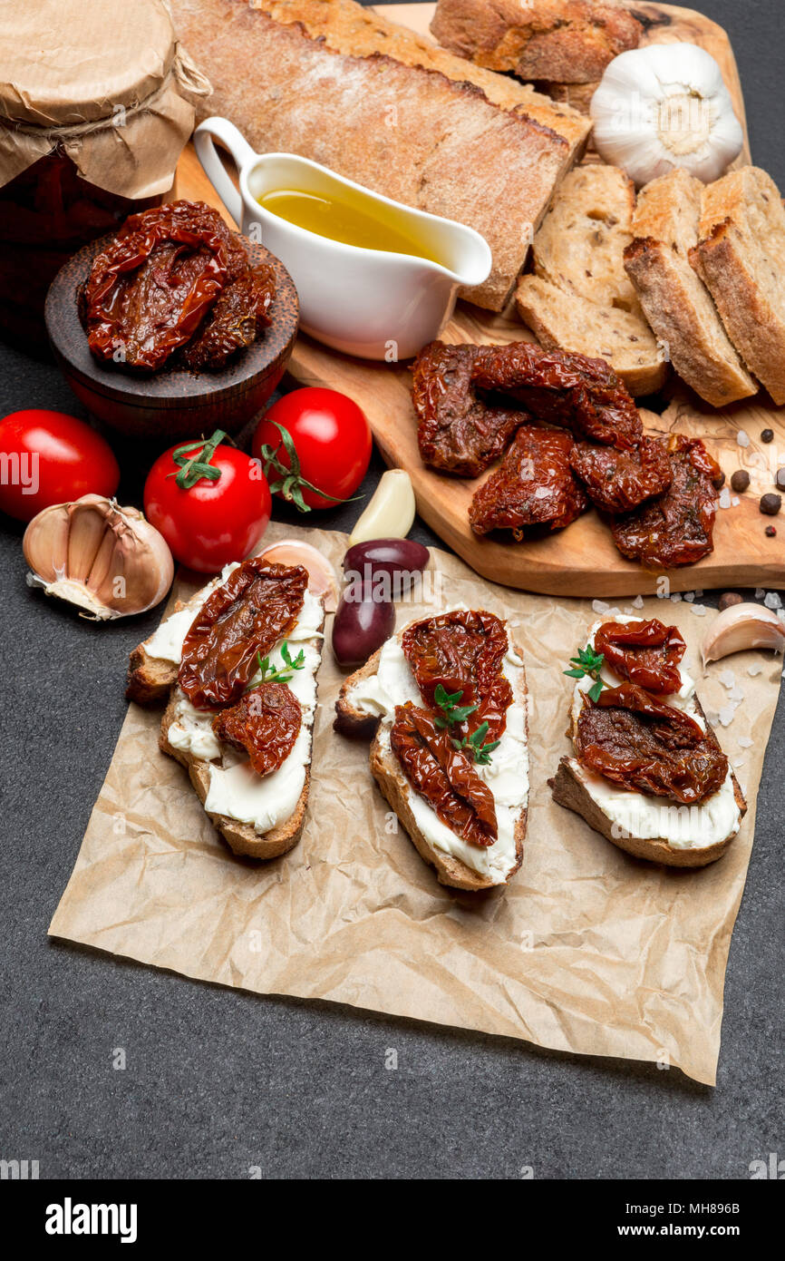 bruschetta with Canned Sundried or dried tomato halves on craft pepper Stock Photo
