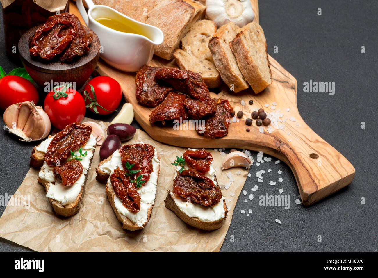bruschetta with Canned Sundried or dried tomato halves on craft pepper Stock Photo