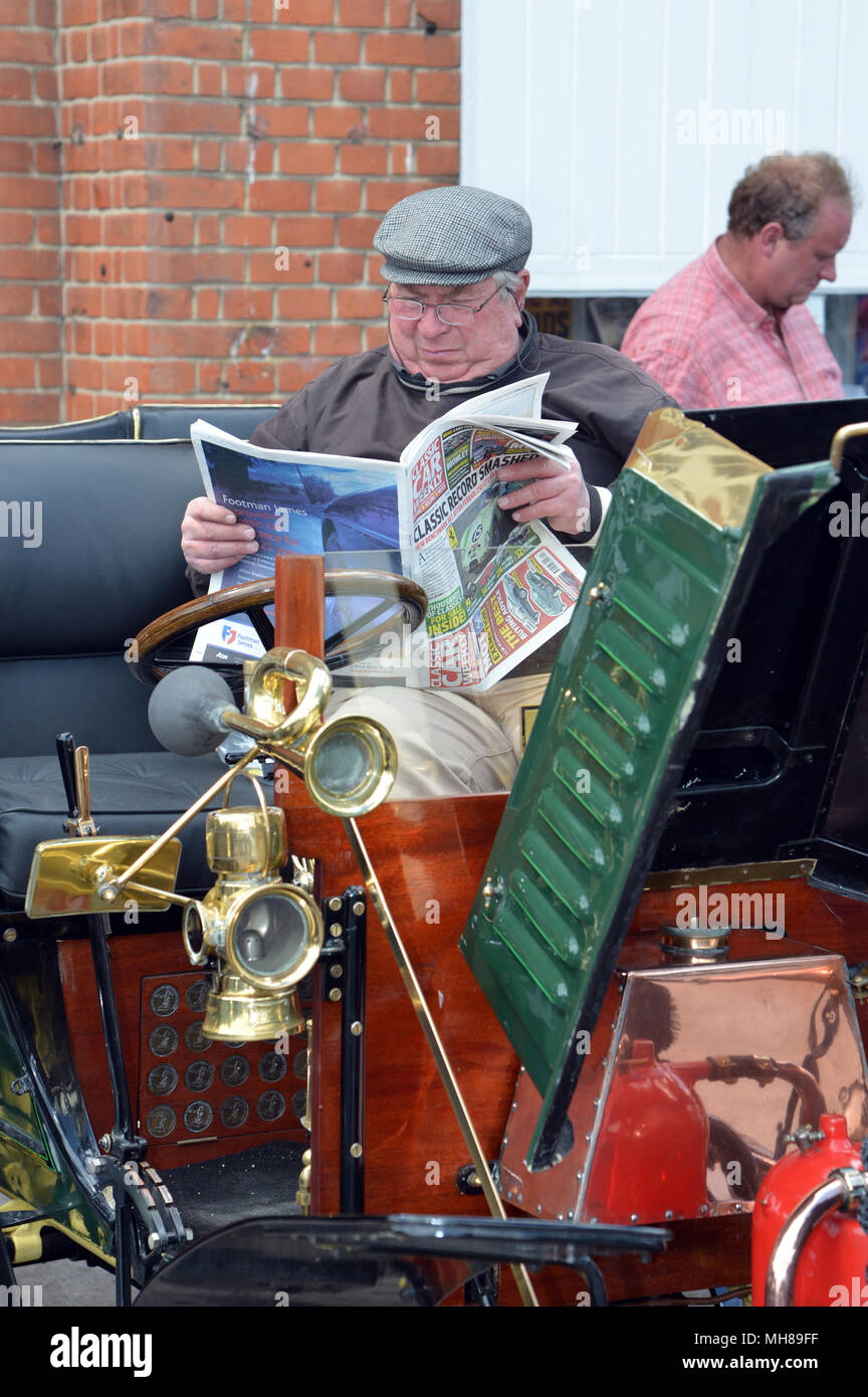 Driver reading a classic car magazine Vintage and classic cars at the Brooklands Double Twelve, 2012 Stock Photo