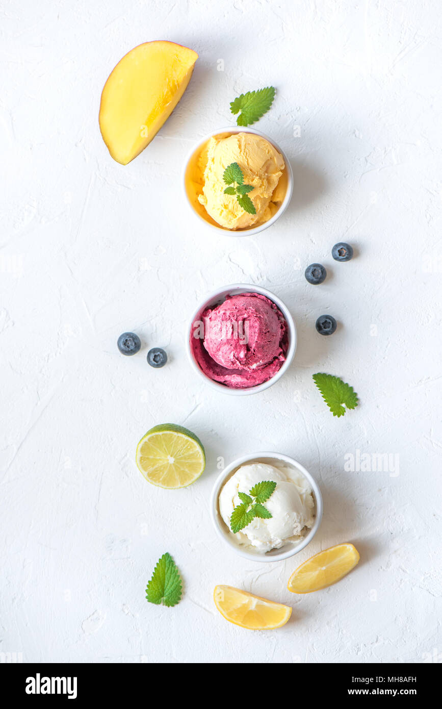 Three various fruit and berries ice creams on white background, copy