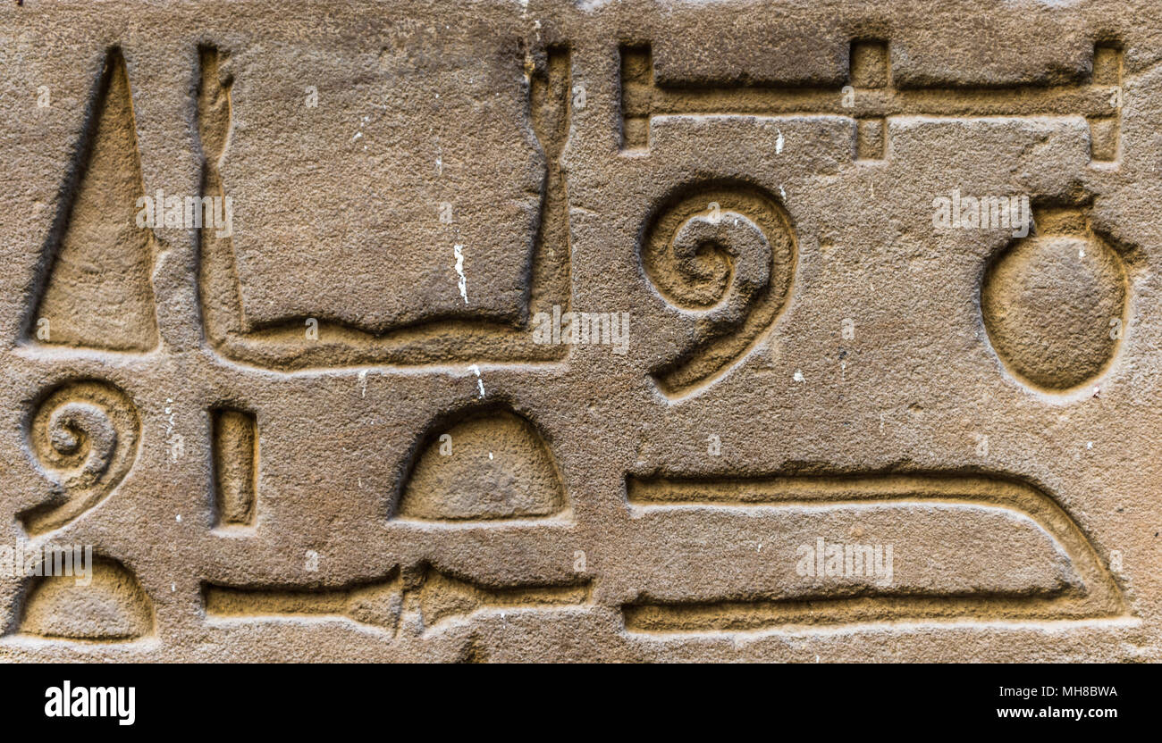 Egyptian hieroglyphs on the wall in a temple Stock Photo - Alamy