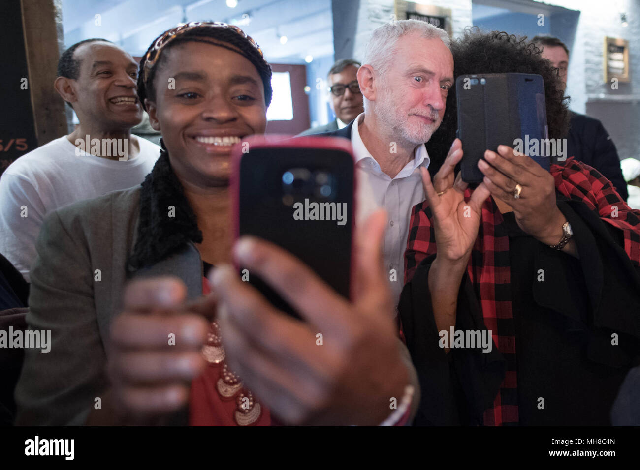 Labour leader Jeremy Corbyn poses for selfies as he meets people from the Caribbean and the West Indies, members of the Stockwell Good Neighbours community group, at the Oval House Theatre in Kennington, south London. Stock Photo