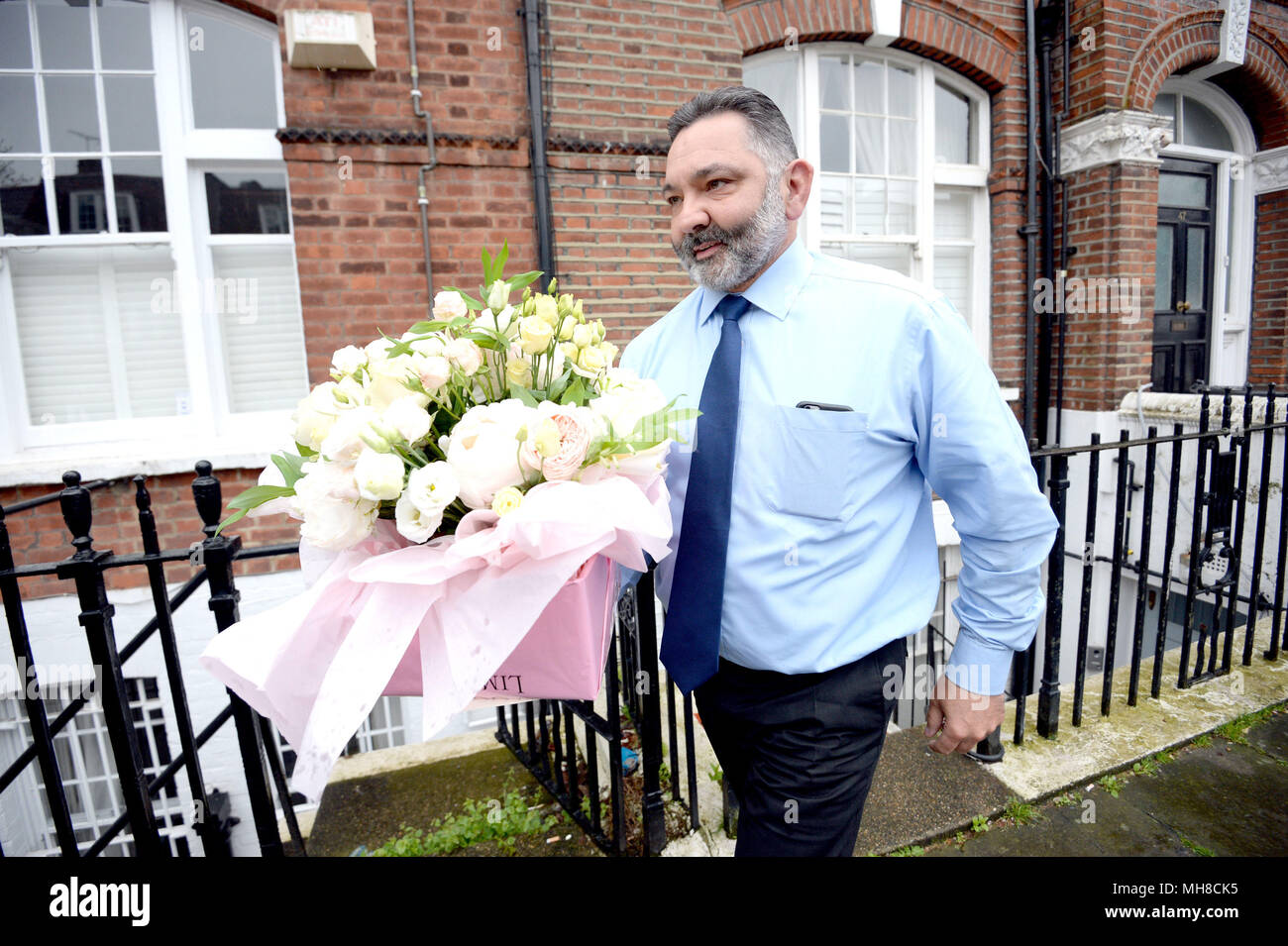 Flowers being delivered to the west London home of Amber Rudd after she resigned as Home Secretary amid claims she misled Parliament over targets for removing illegal migrants. Stock Photo