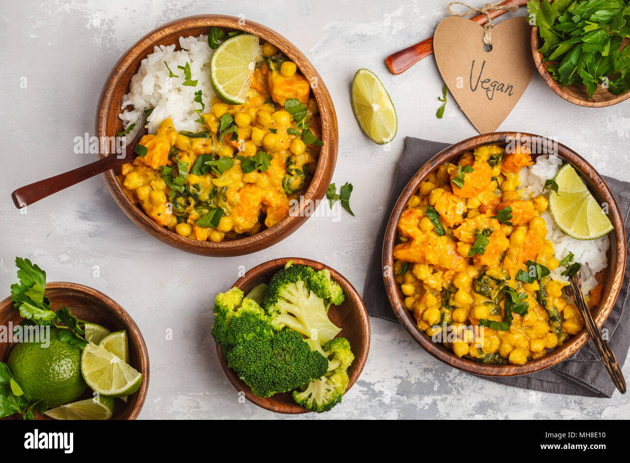 Vegan Sweet Potato Chickpea curry in wooden bowl on a light background, top view, food flat lay. Healthy vegetarian food concept. Stock Photo