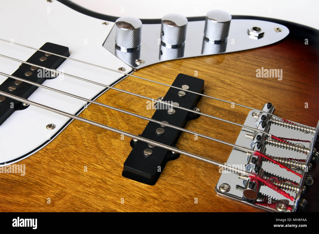 Part four string bass guitar close-up isolated on white background