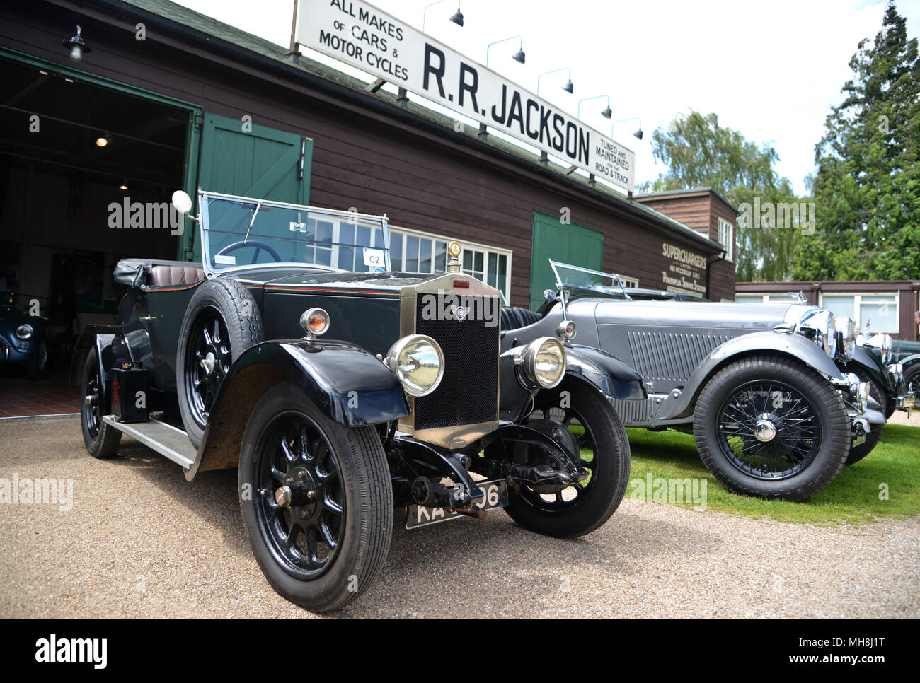 vintage cars outside the sheds of the motoring village at Brooklands Stock Photo