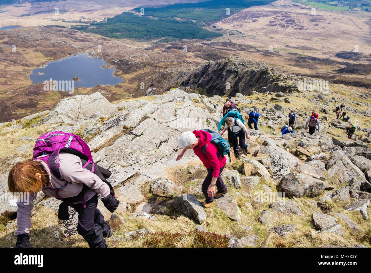Hikers climbing on Daear Ddu east ridge on Carnedd Moel Siabod mountain in mountains of Snowdonia National Park. Wales, UK, Britain Stock Photo