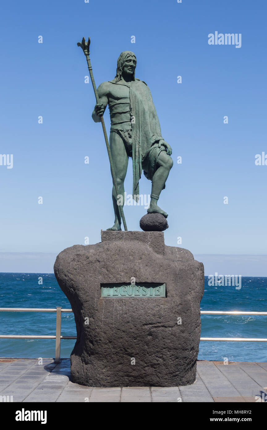 Statue of an ancient Canary Islands native guanche on the waterfront in the city of Candelaria Stock Photo