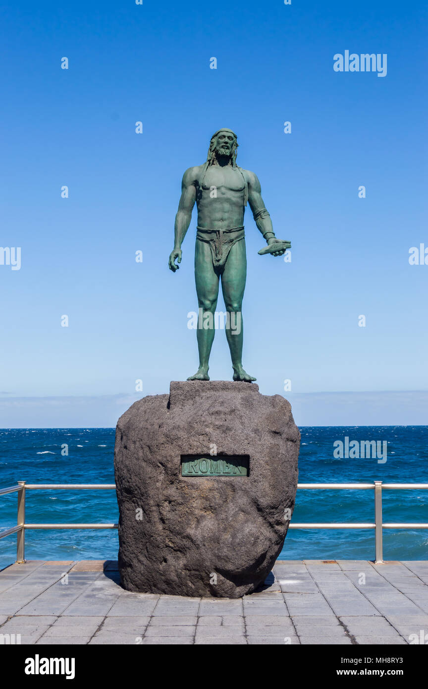 Statue of an ancient Canary Islands native guanche on the waterfront in the city of Candelaria Stock Photo