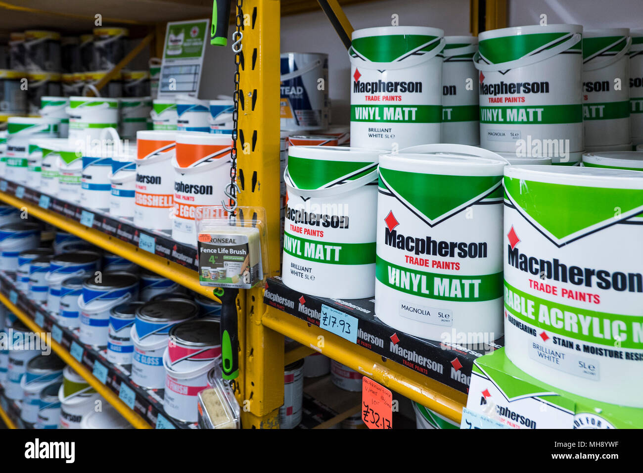 Pots of paint on racks inside a DIY shop. Stock Photo