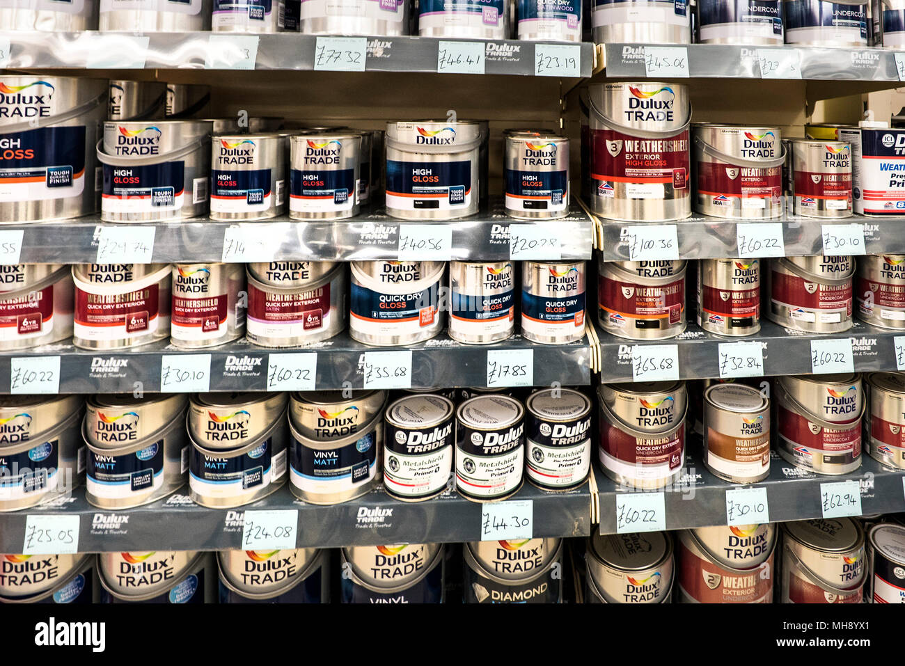 Shelves full of cans of paint on sale in a DIY shop. Stock Photo
