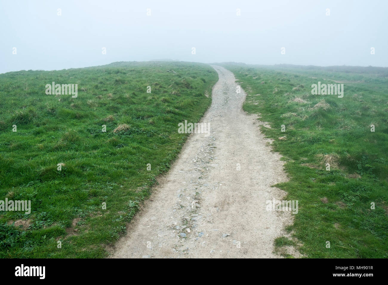 UK weather - Coastal mist over a rocky track on East Pentire in Newquay Cornwall. Stock Photo