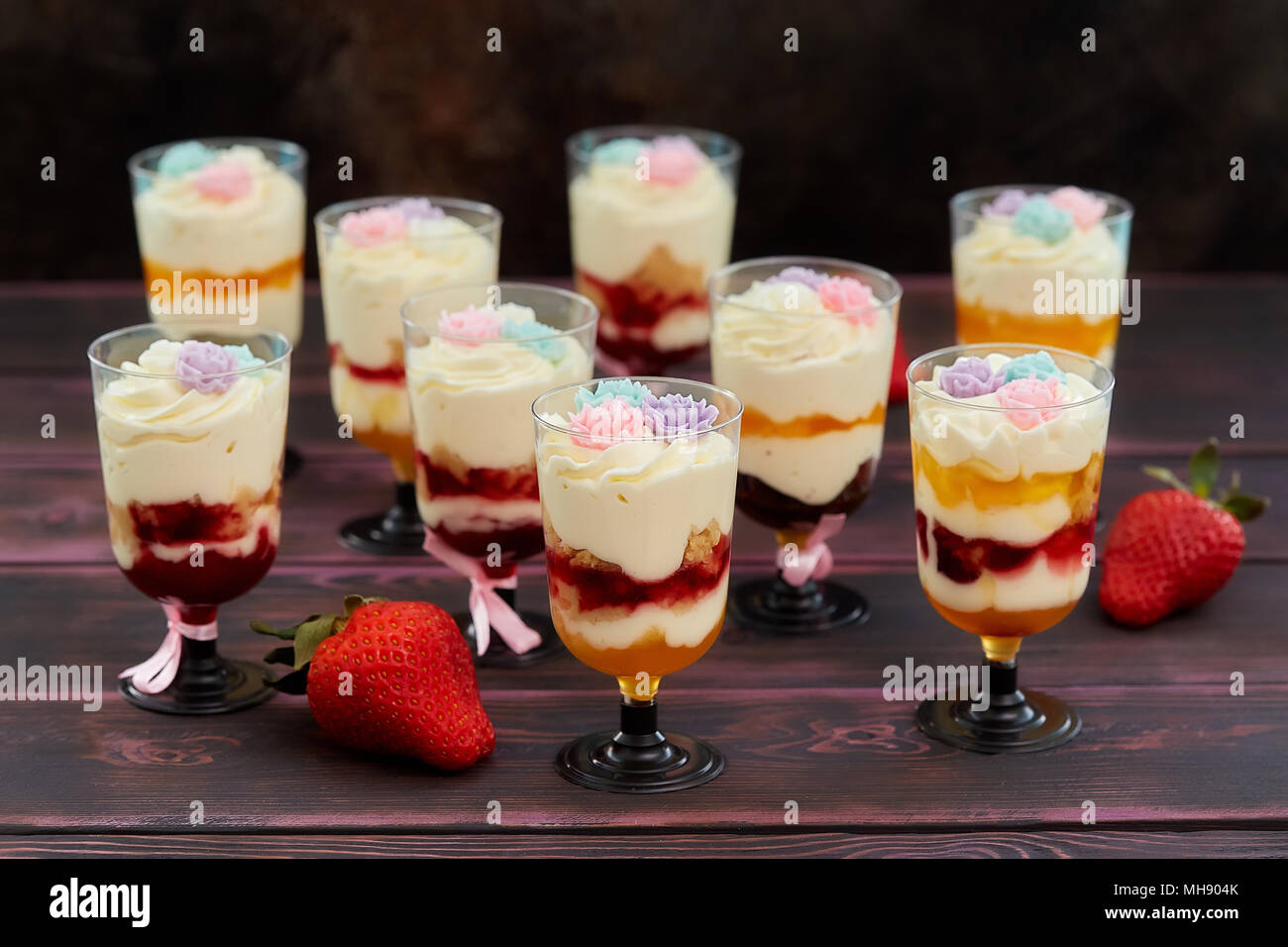 Cake with strawberry served in glass shots, wooden background Stock Photo