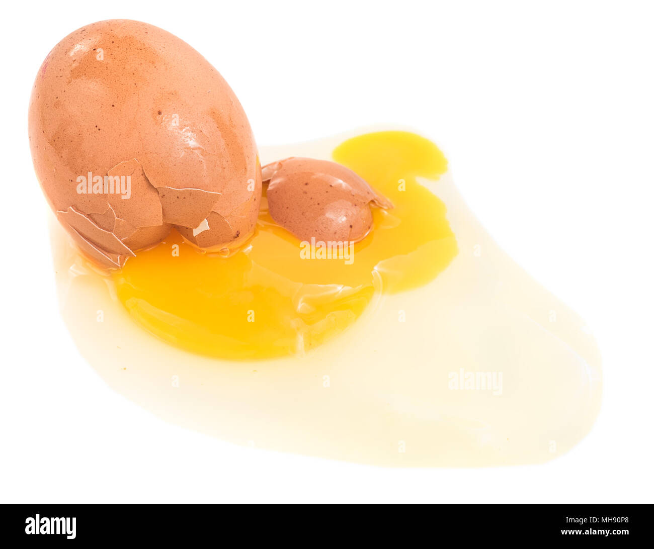 Broken egg isolated on a white background with a bright yellow yolk ...