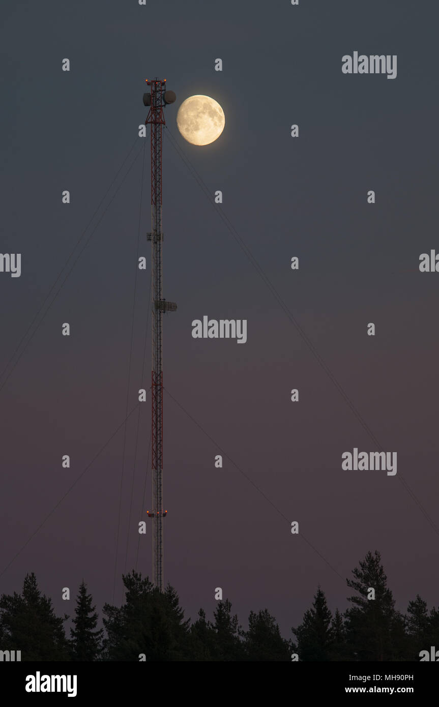 Moon and Communications tower. Stock Photo