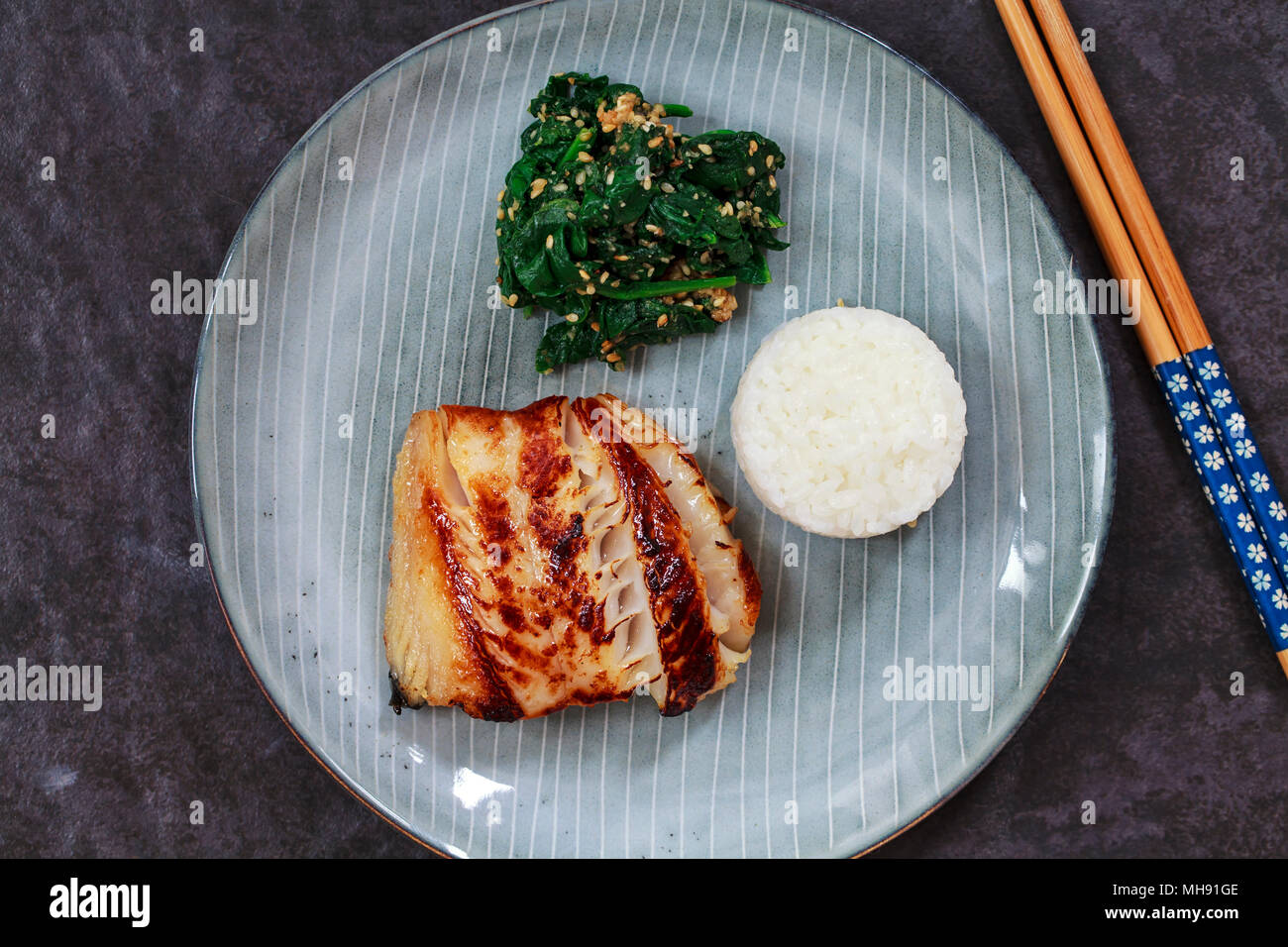 Miso marinated black cod with Japanese spinach salad gomaae Stock Photo