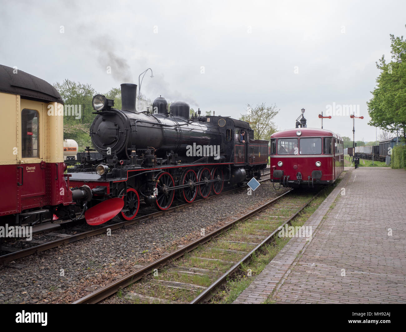 Steam engine and railbus at Simpelveld station, part of the heritage line ZLSM in Limburg Stock Photo