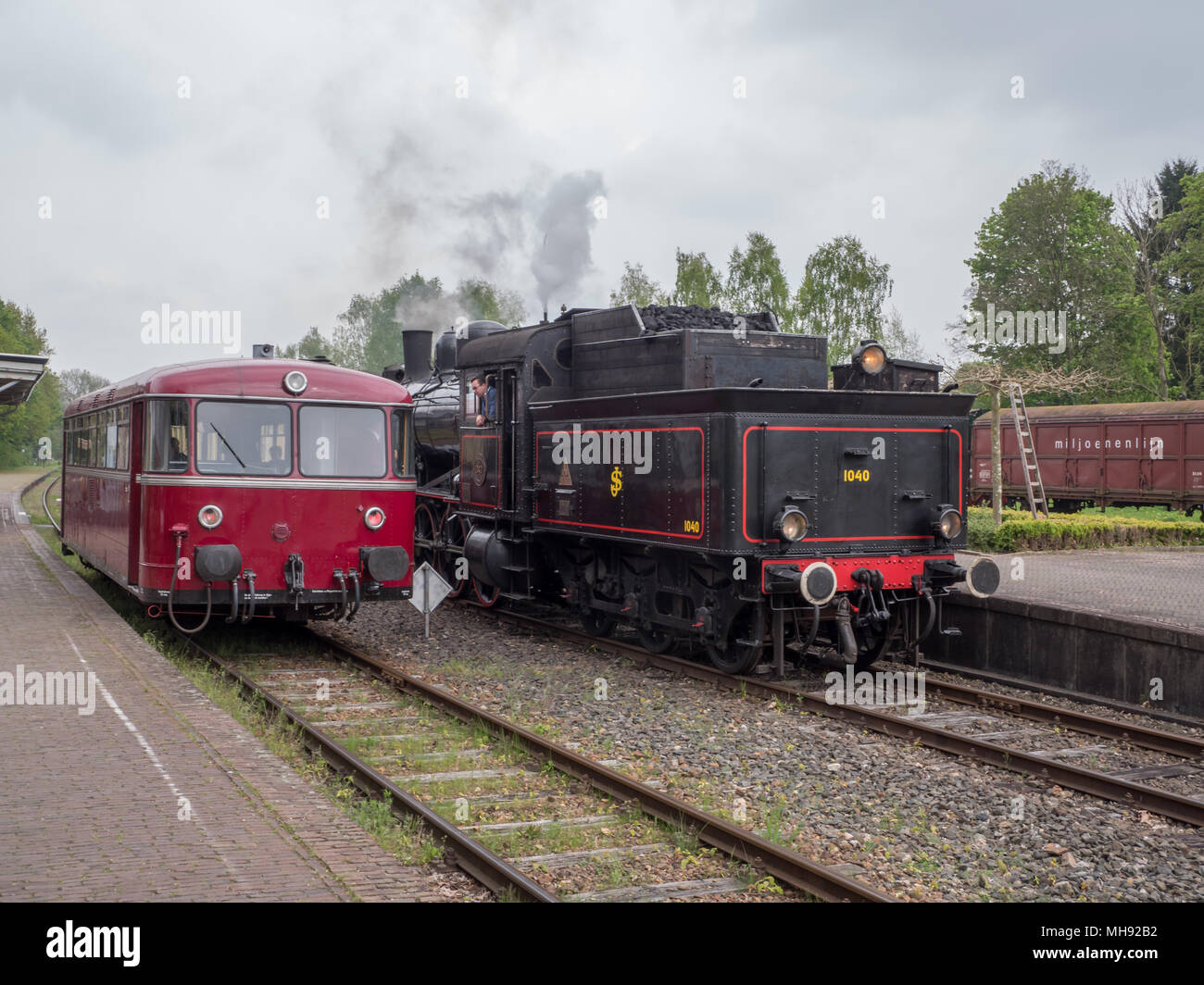 Steam engine and railbus at Simpelveld station, part of the heritage line ZLSM in Limburg Stock Photo