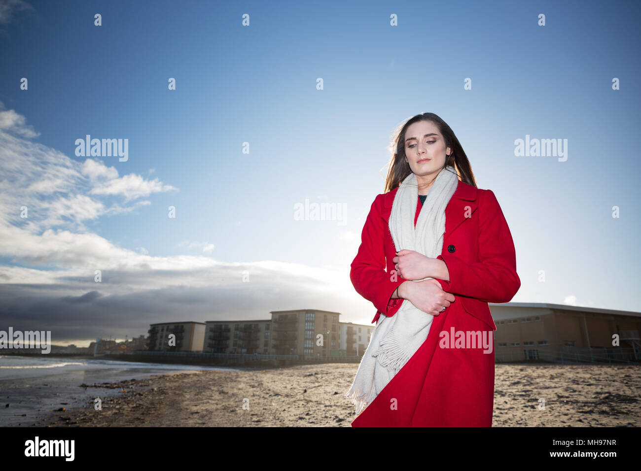 Woman at the beach, showing emotion and expression dealing with anxiety, grief, depression and mental health. Stock Photo