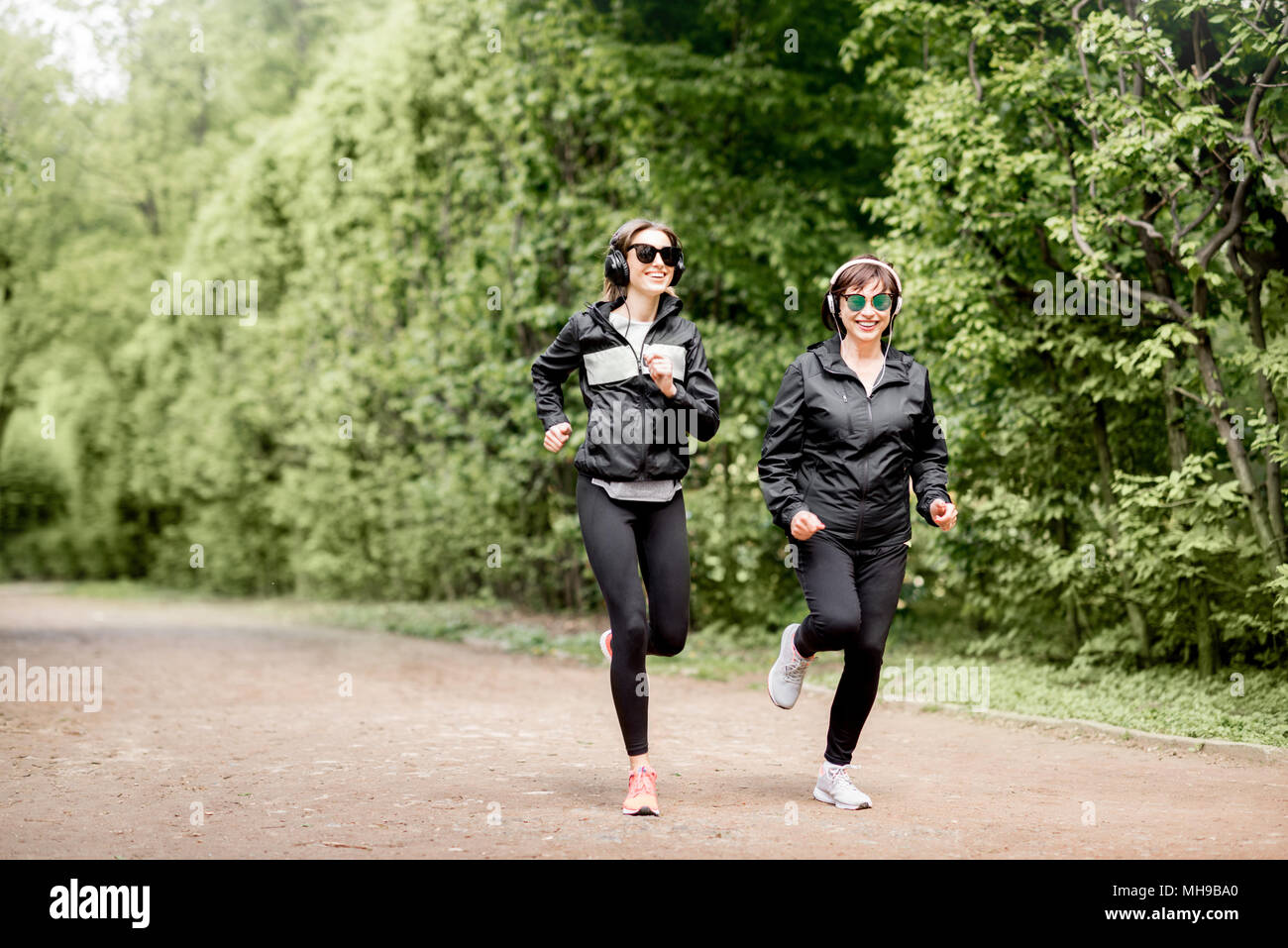Two Women Running In Park Stock Photo, Picture and Royalty Free Image.  Image 74107441.