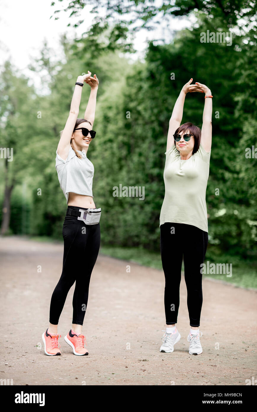 Two women exercising in the park Stock Photo
