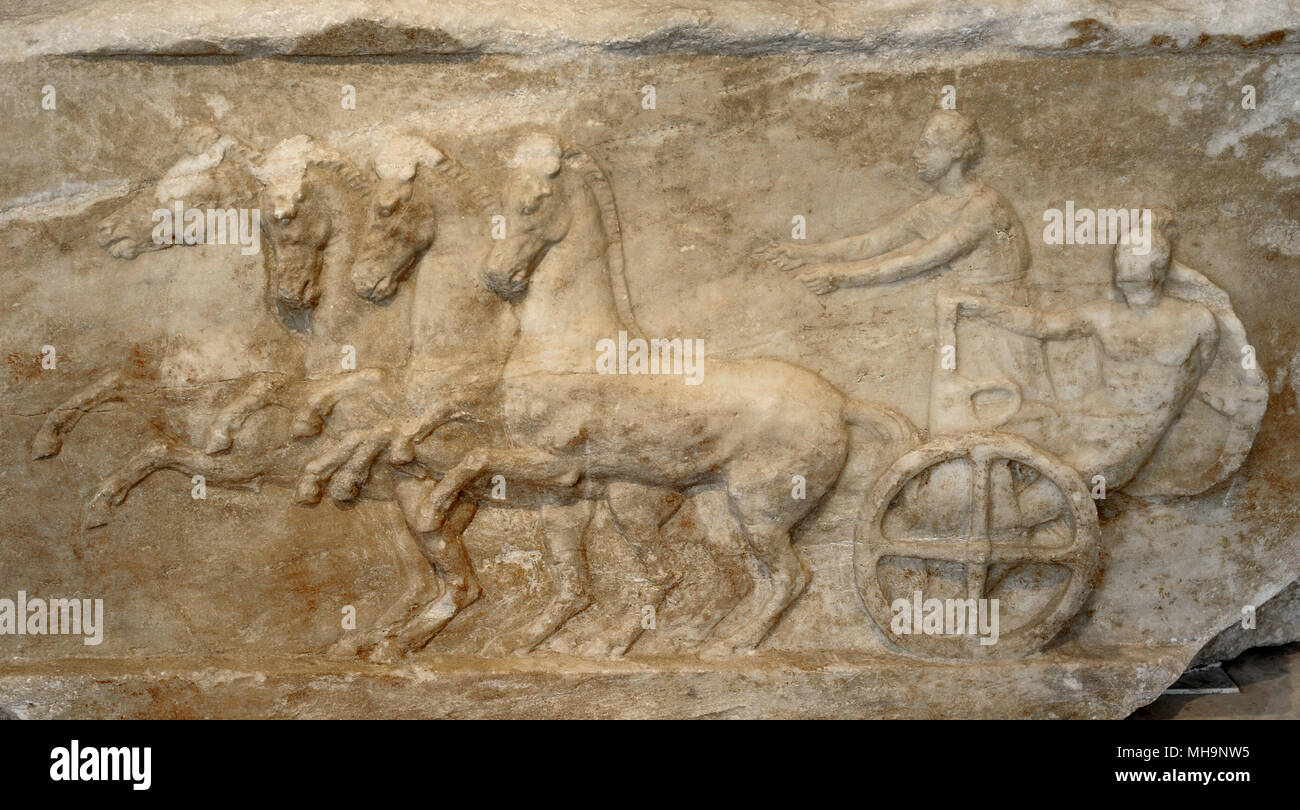 Base of a dedication, detail. The relief depicts a scene from the apobates race. In the apobates race, the fully armed athlete jumped to the ground and then had to remount on the fast-moving chariot. Late 4th-Early 3rd century BC. Acropolis Museum. Athens. Greece. Stock Photo