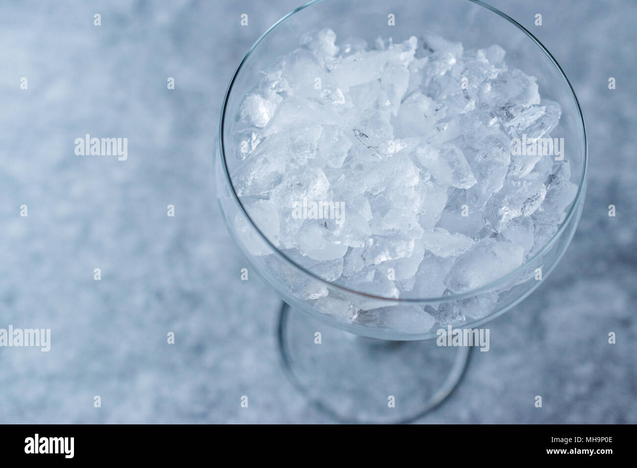 Crushed Ice In Cocktail Glass On Blue Surface. Beverage Concept