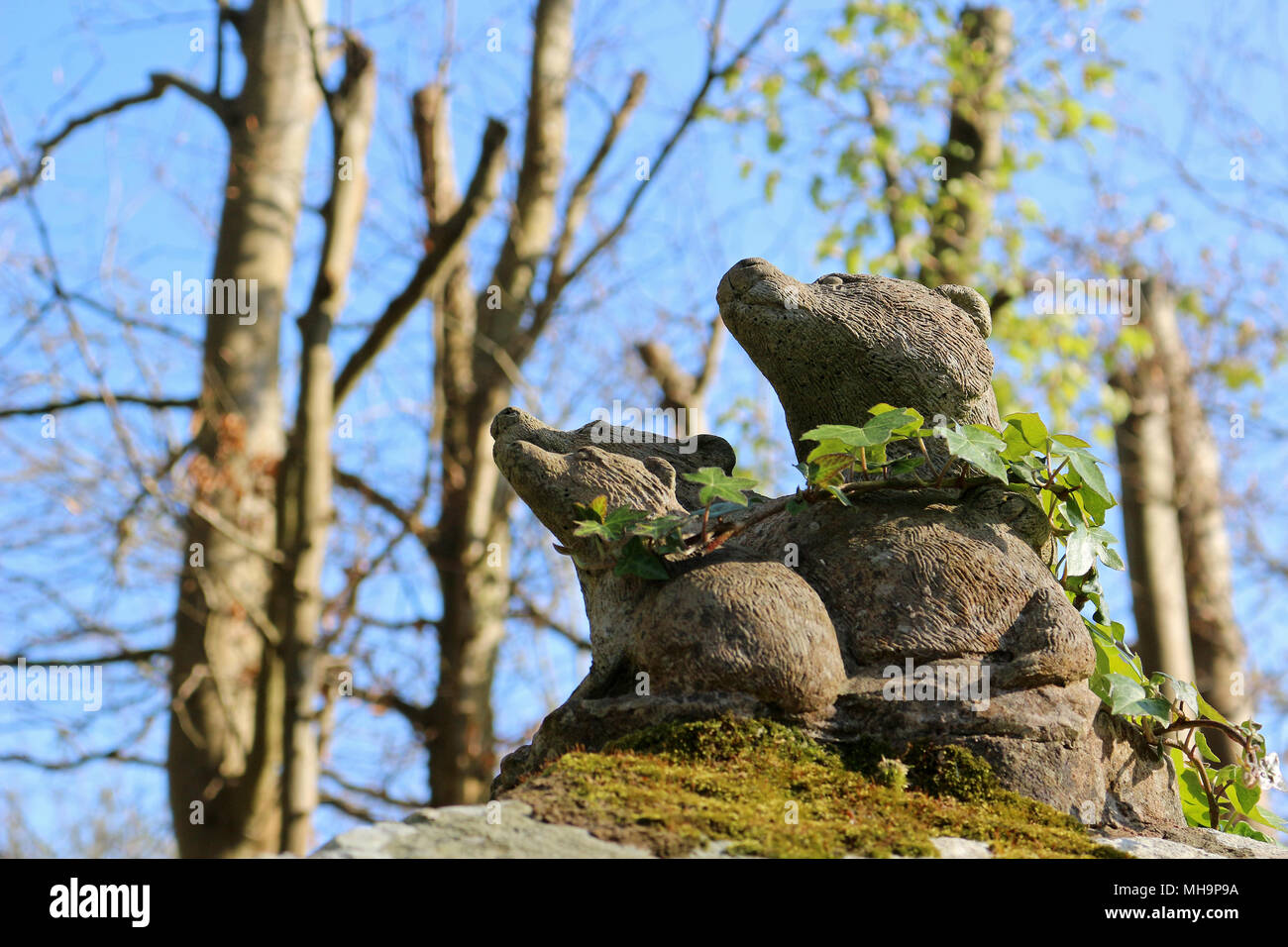 Stone garden ornaments. Badger family decoration Stock Photo Alamy