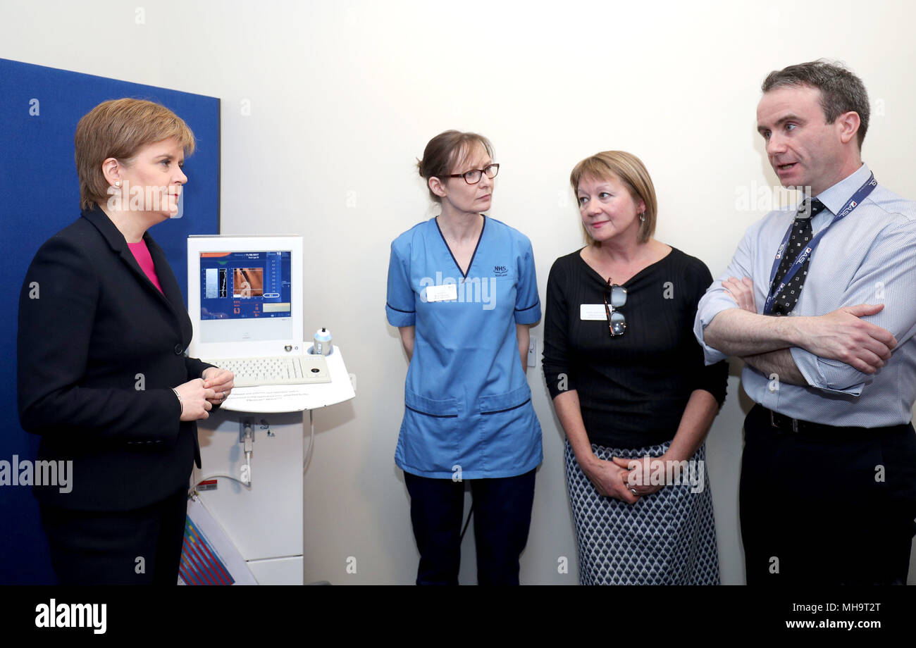 Embargoed to 0001 Tuesday May 01 (Left to right) First Minister Nicola Sturgeon meets nurse practitioner Kim Macbeth, mental health nurse Helene Leslie and consultant psychiatrist Roger Smyth, during a visit to the Edinburgh Royal Infirmary, as she marks the minimum unit pricing for alcohol coming into force and meet patients with chronic liver problems and specialist clinicians. Stock Photo