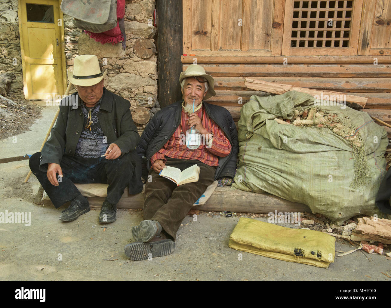 Local Tibetan drinking rice wine in the village of Jiaju, Sichuan, China Stock Photo