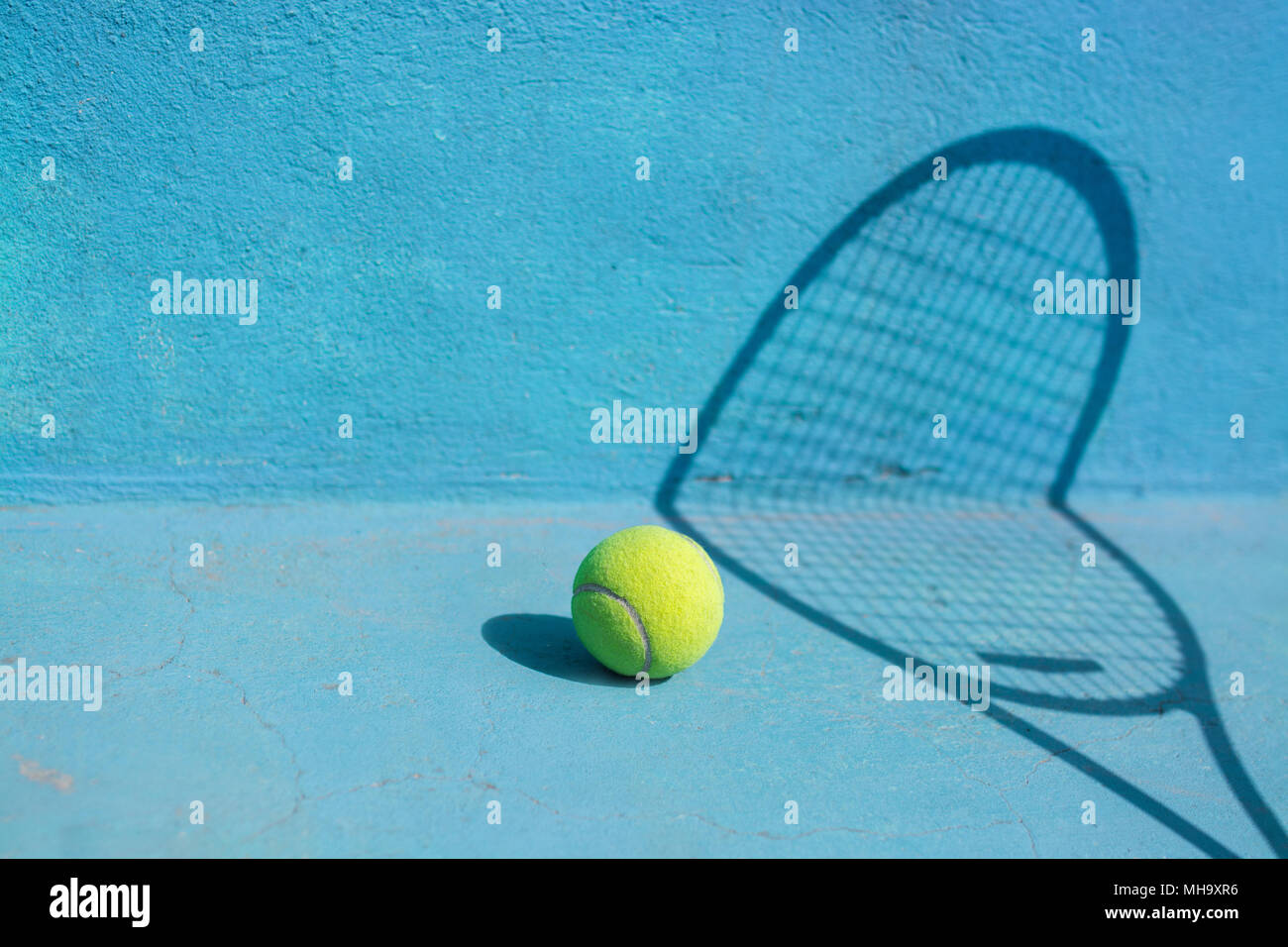 Tennis ball and racket on blue court.Sport Concept Stock Photo