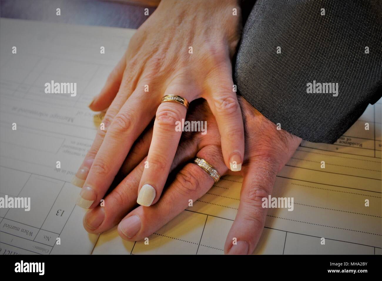 A newly wed couple displaying their wedding rings before they sign the register of marriage Stock Photo Alamy