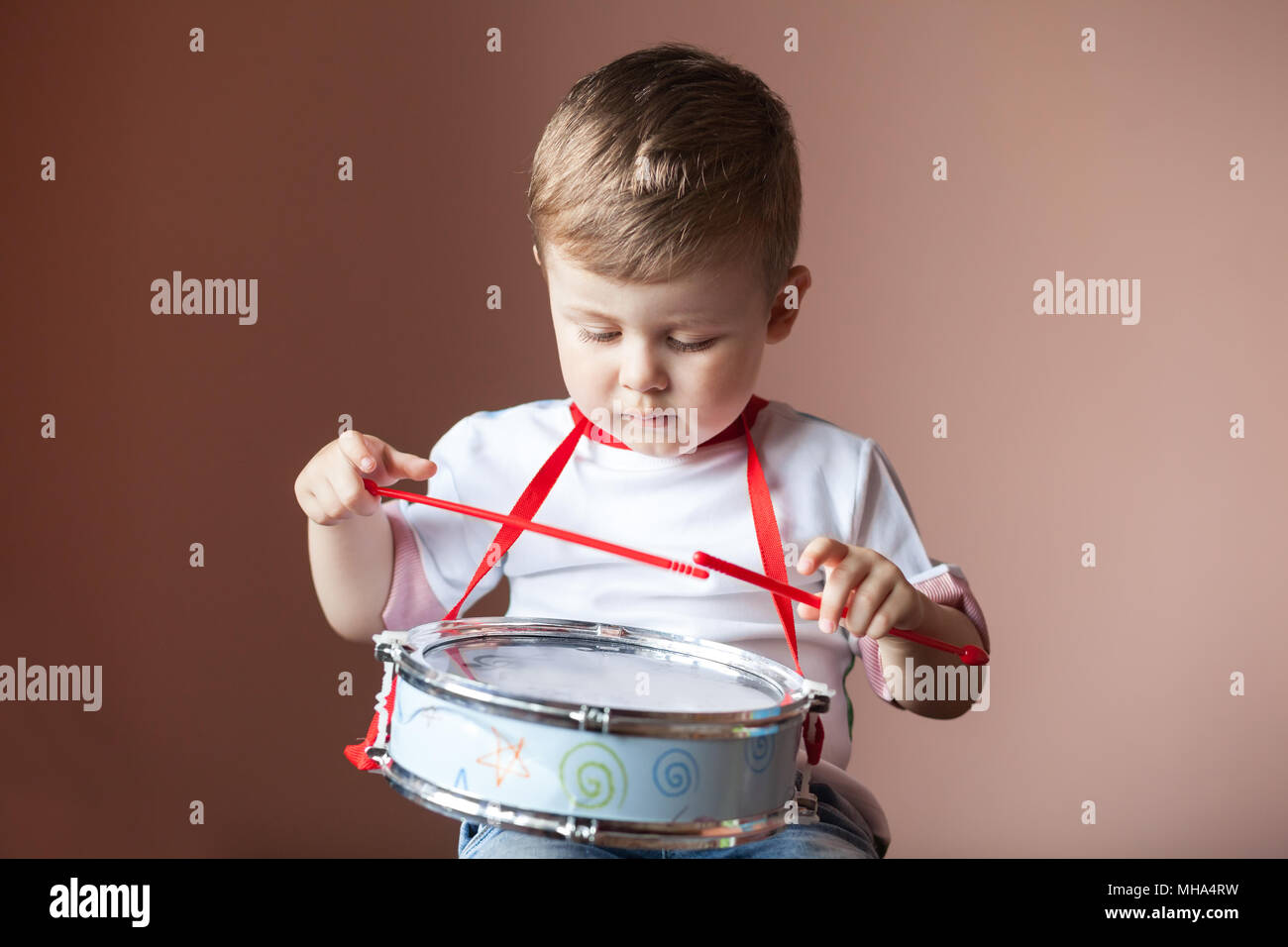 Little boy playing the drum. Lovely baby boy. Child development concept Stock Photo Alamy