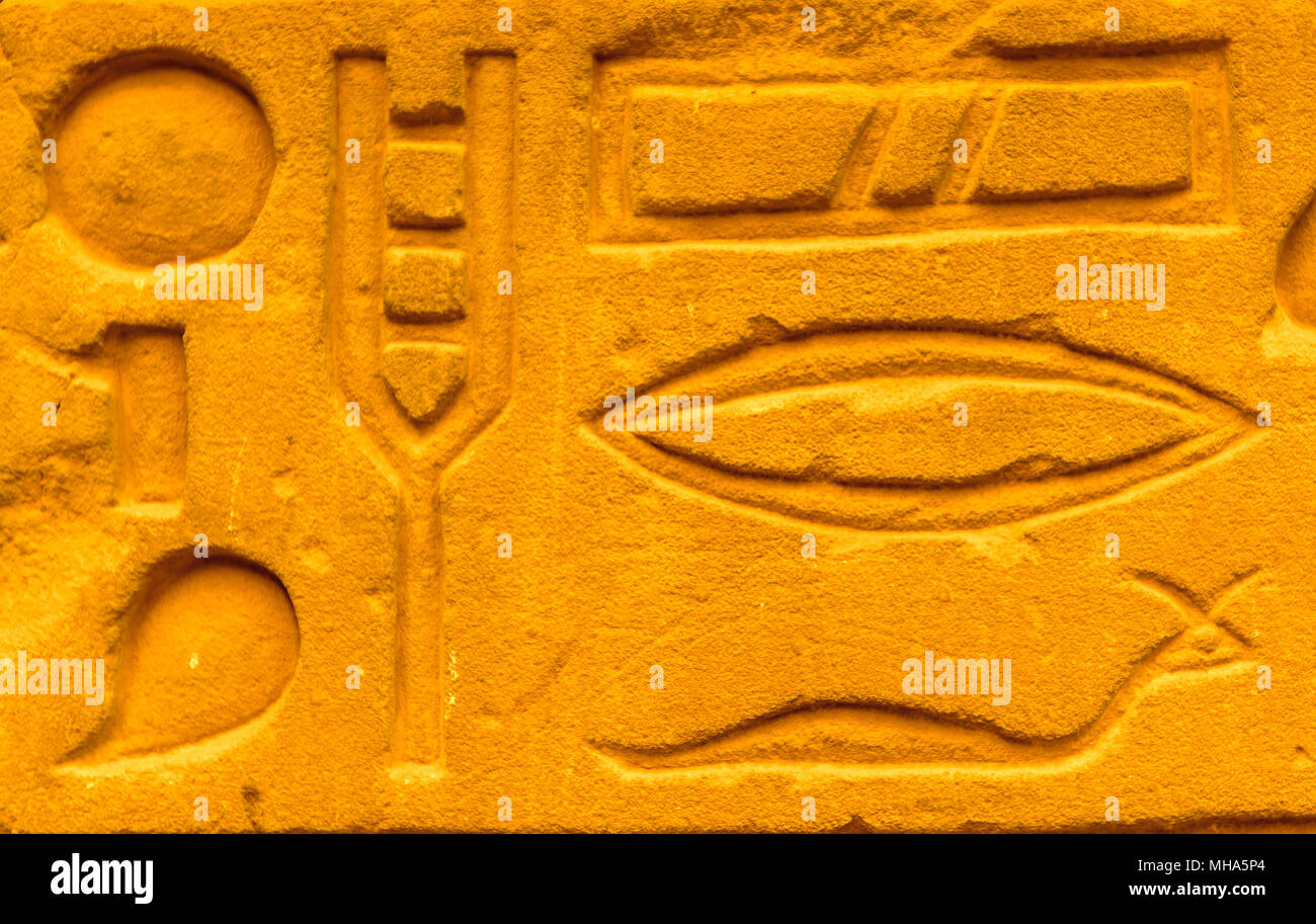 Egyptian hieroglyphs on the wall in a temple Stock Photo - Alamy