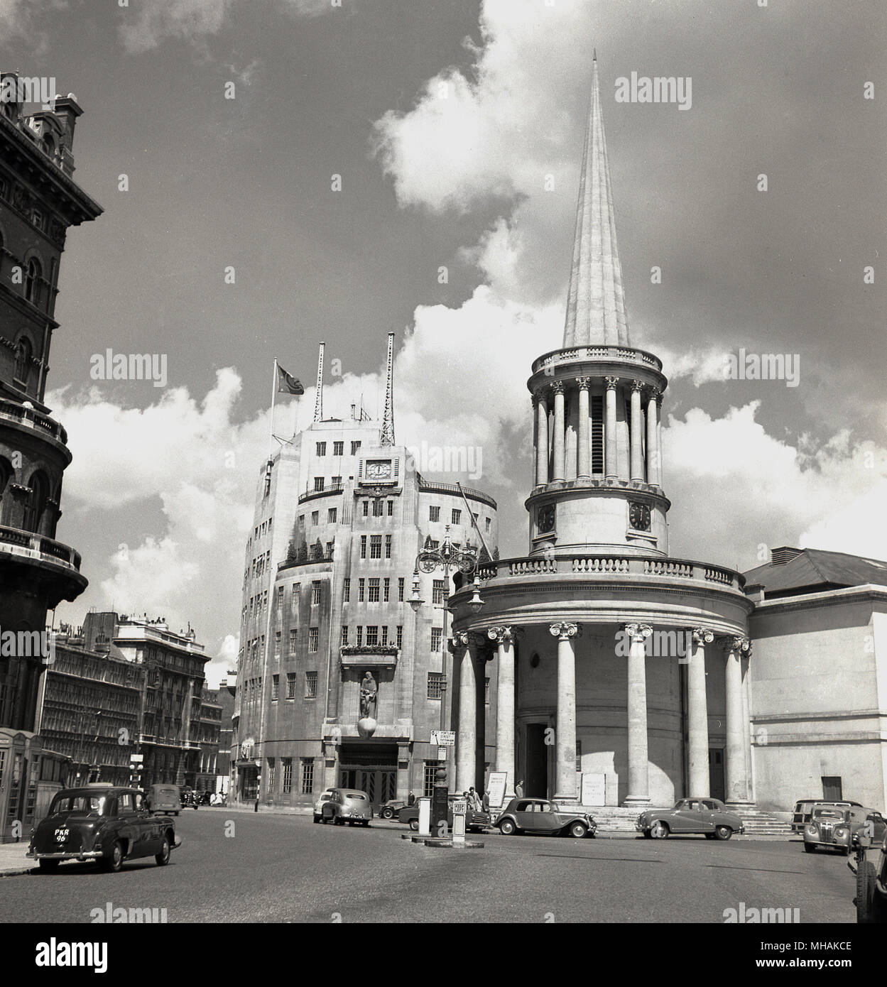 1950s, historical, exterior view of All Souls Church at Langham Place, london, with Broadcasting House, the central london home of the BBC, behind it. The church with its tall elegant spire was designed in regency style by John Nash. Stock Photo