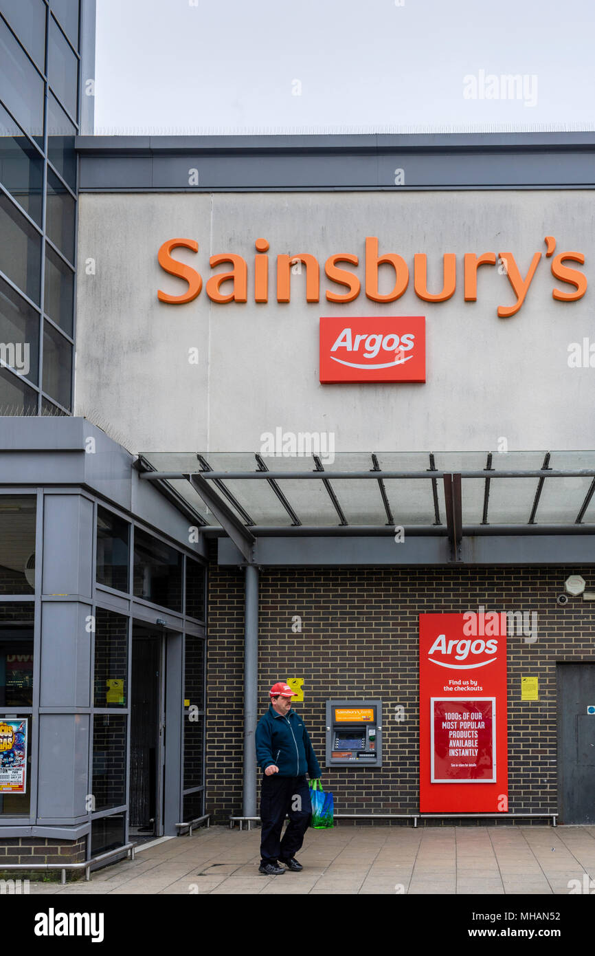 An orange Sainsbury's and red sign - the two retailers have merged in 2016 Stock Photo