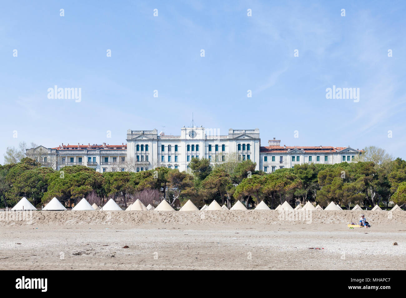 The former luxury hotel Grand Hotel des Bains, Lido di Venezia (Venice  Lido, Lido Island), Venice, Veneto, Italy from the beach. Woman sunbathing  Stock Photo - Alamy