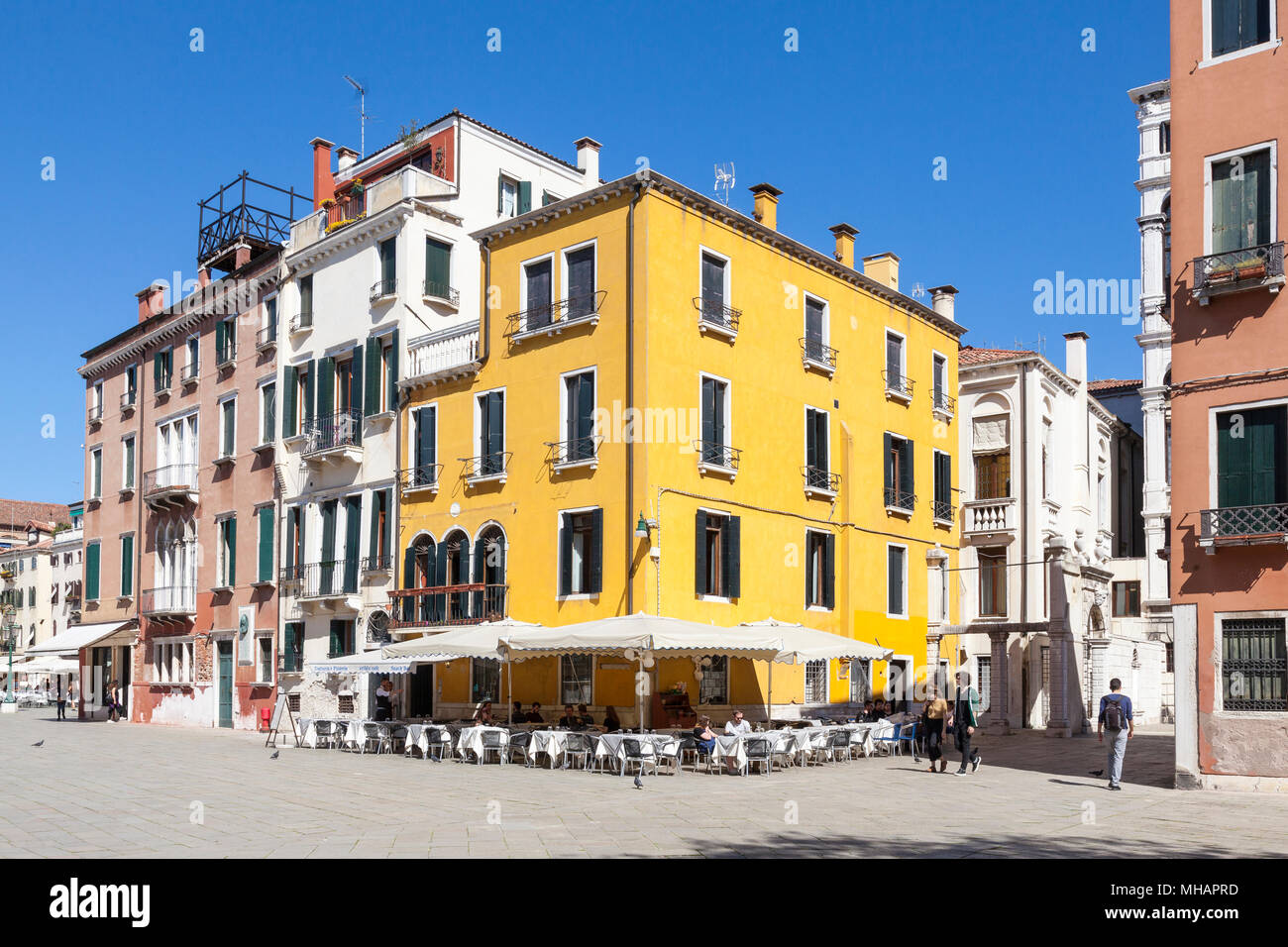The colourful yellow Artblu cafe Pizzeria and Trattoria, Campo Santo Stefano, San Marco, Venice, Veneto, Italy Stock Photo