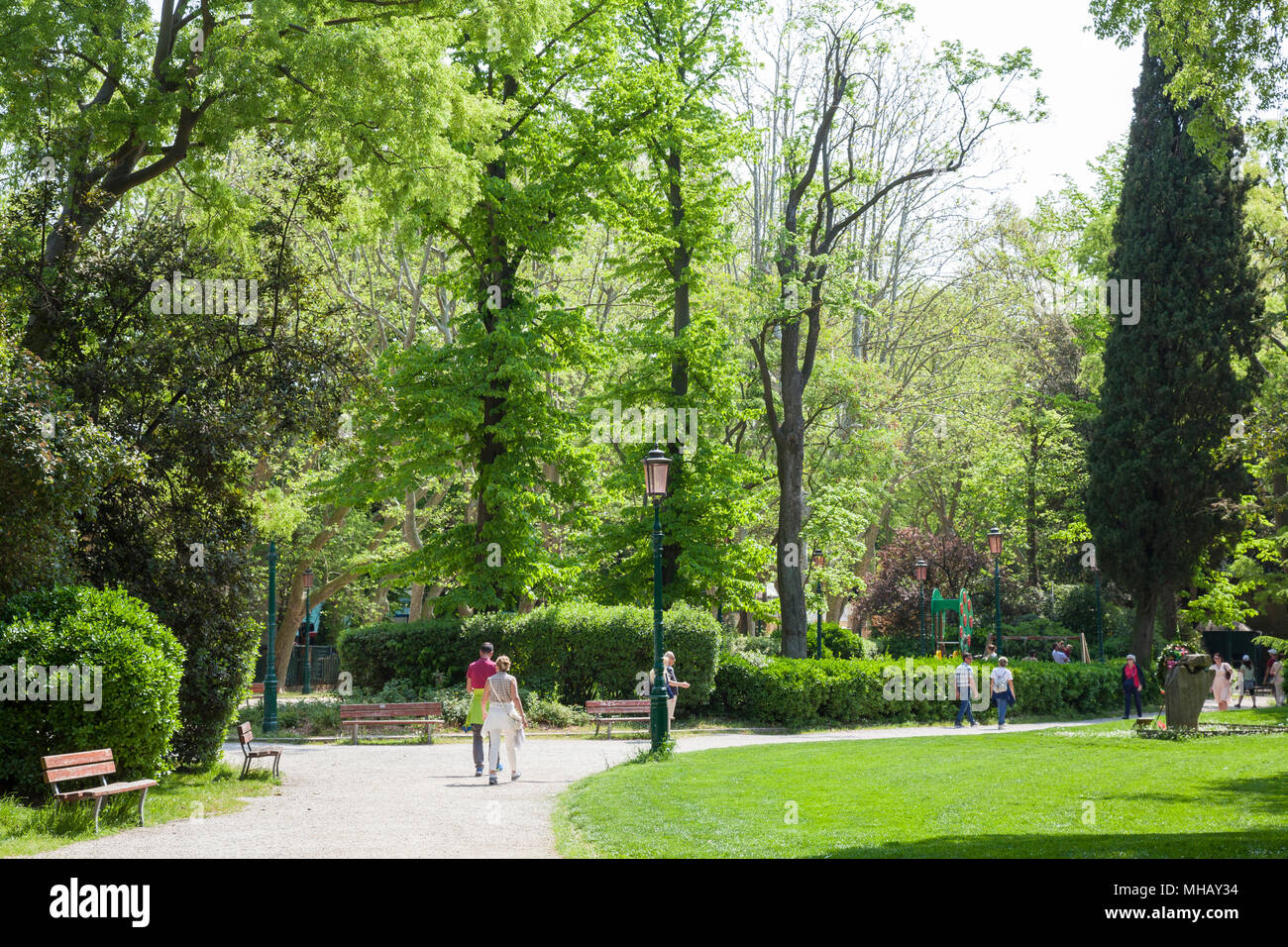 Venice in spring. People walking in the Giardini Pubblici with lush greenery and trees, Castello, Venice, Veneto, Italy Stock Photo