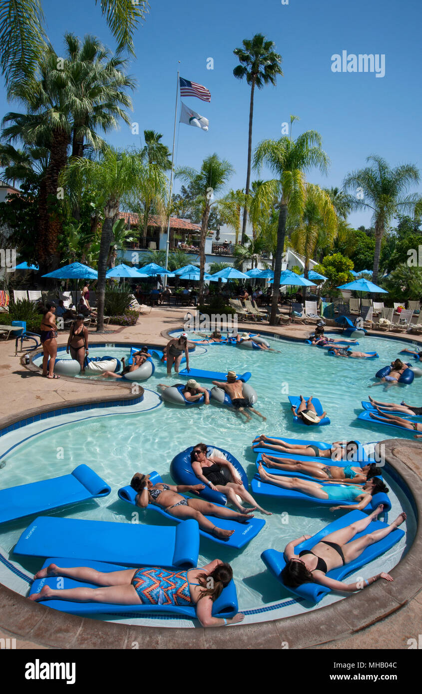 People floating on rafts in mineral hot springs pool at Glen Ivy Hot Springs, a day spa in