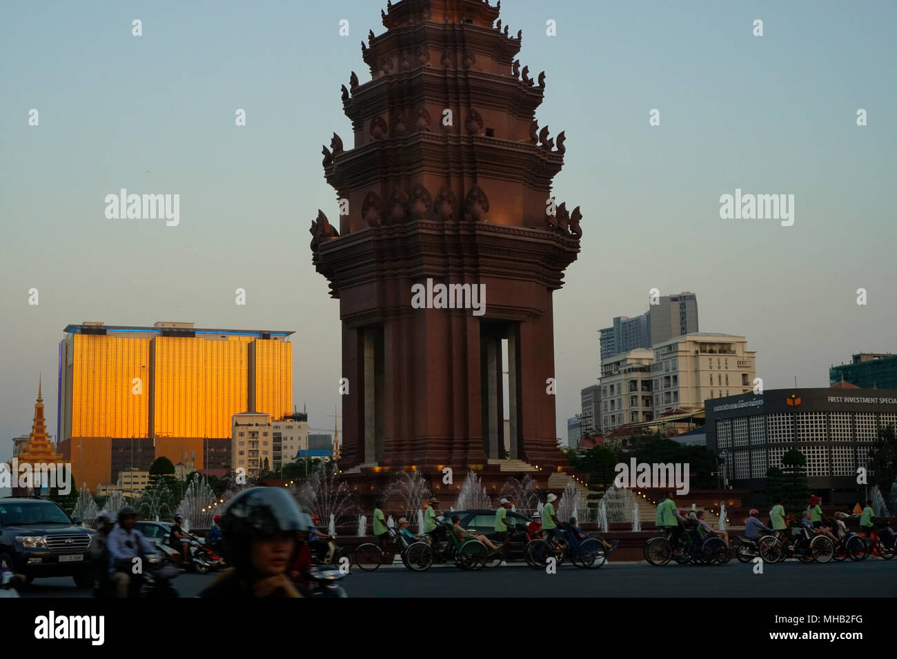 Independence Monument in Independence Park and the Naga 2 Hotel and Casino in the background, Phnom Penh; Cambodia; Stock Photo