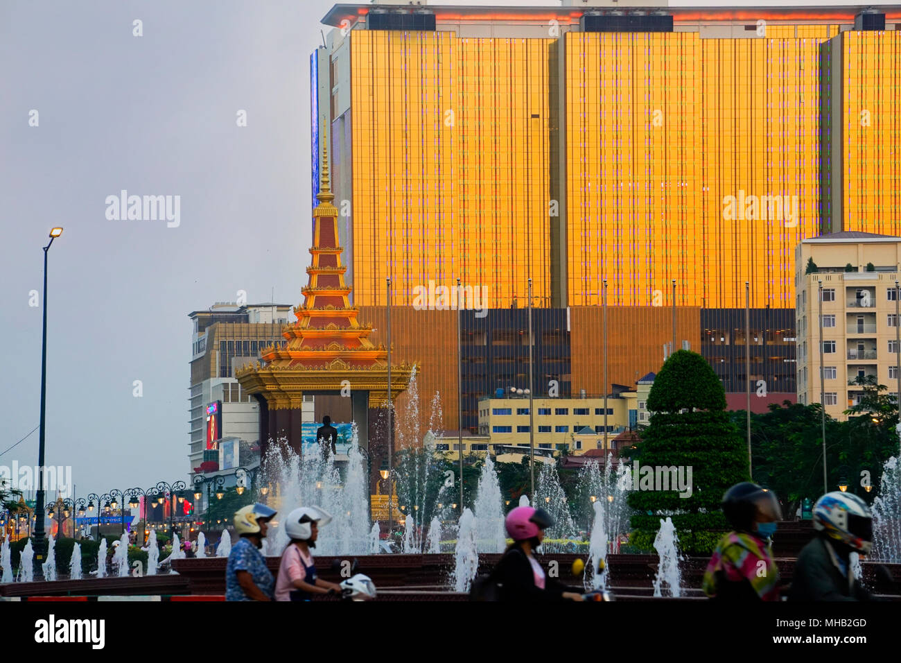 Monument to King Norodom Sihanouk in  Independence Park and the Naga 2 Hotel and Casino, Phnom Penh city, Cambodia; Stock Photo